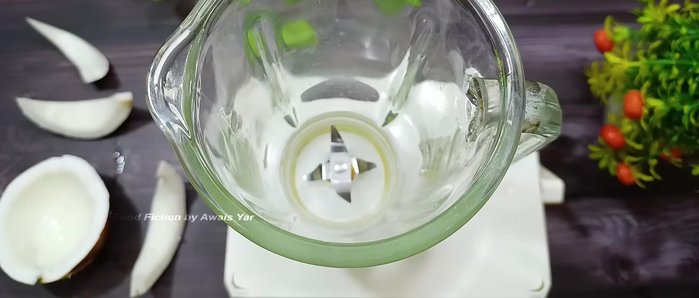 Place the coconut slices into a blender jug, leaving some space.