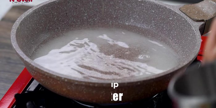 In a pan, combine 1/2 cup sugar and 1 cup water. Bring to a boil and add soaked saffron strands. Boil for 3-5 minutes until slightly thickened. Set aside and keep warm.