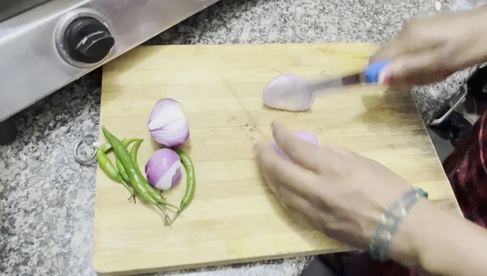 Finely chop onions and green chilies (do not grind).