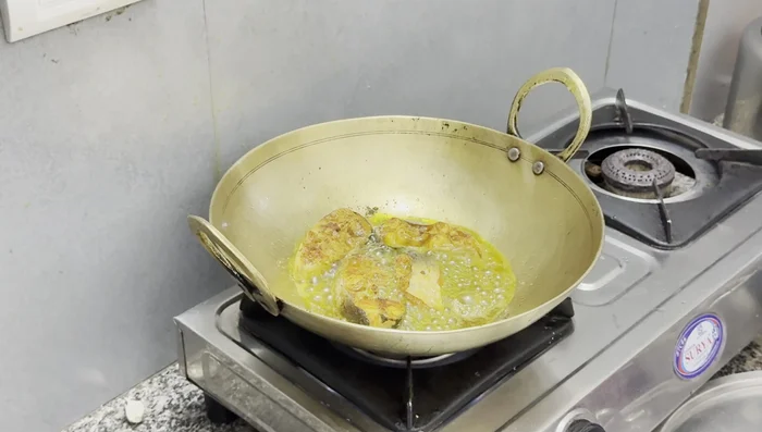 Fry in batches, ensuring the fish doesn't break. The fish releases oil, so you may not need to add more.
