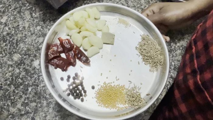 Grind yellow mustard, black pepper, red chili, garlic, ginger, poppy seeds, cumin seeds, and shahjeera into a fine paste.