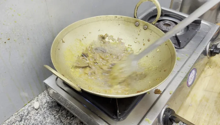 Add the ground spice paste, turmeric powder, coriander powder, and red chili powder. Fry well.