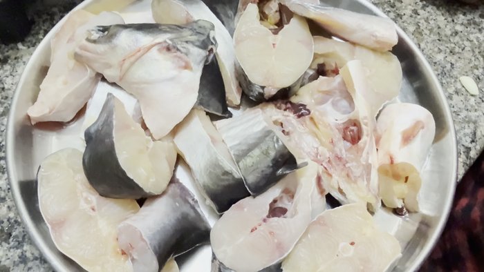 Wash fish pieces, rubbing with flour and salt to remove blood, dirt, and smell.