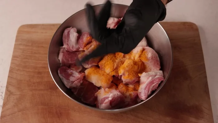 Marinate pork with salt and turmeric.