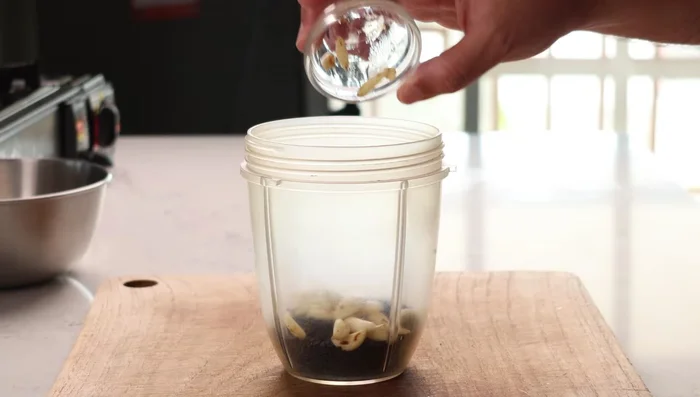 Blend sesame seeds, garlic, and water to create a paste.