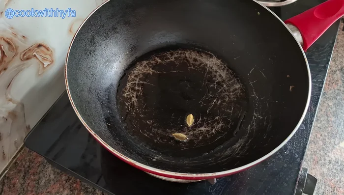 Add 2 green cardamoms, ½ star anise, and the finely chopped onion. Sauté until softened, do not brown.