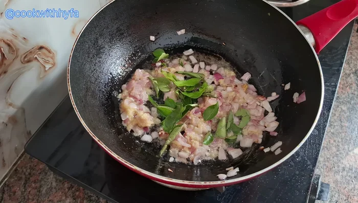 Add ½ a fistful of fresh curry leaves and the finely chopped tomato.