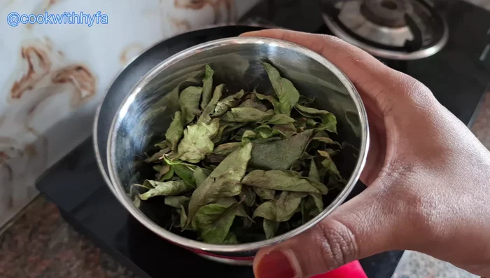Grind the roasted curry leaves into a powder using a grinder jar.