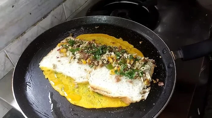 Cook on medium flame, adding more oil and spreading it with a brush. Fold and cook until golden brown.