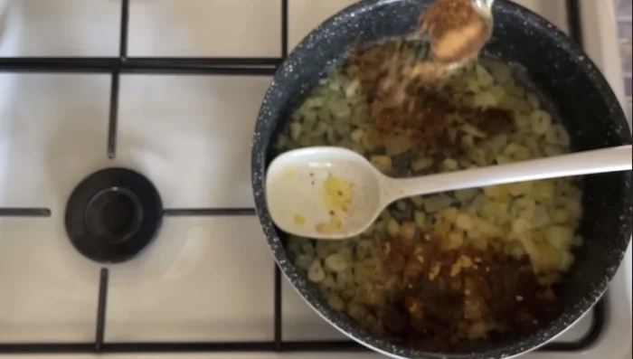 Add garam masala, ground ginger, ground coriander, 1/2 tsp paprika, ground cumin, 1 tsp turmeric, and crushed cardamom pods. Cook for 2-3 minutes to release the flavors.