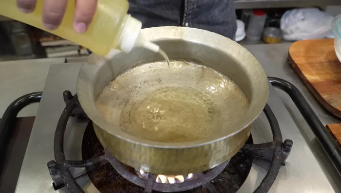 Heat oil in a pan. Add whole garam masala, cardamom, cloves, and fresh biryani leaves. Fry until fragrant.