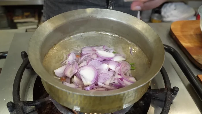 Add thinly sliced onions and salt. Fry until golden brown.