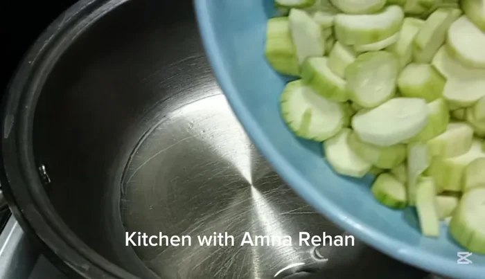 Heat half a cup of oil in a pan. Fry the ridge gourd slices for 1-2 minutes until slightly softened, but not browned. Set aside.