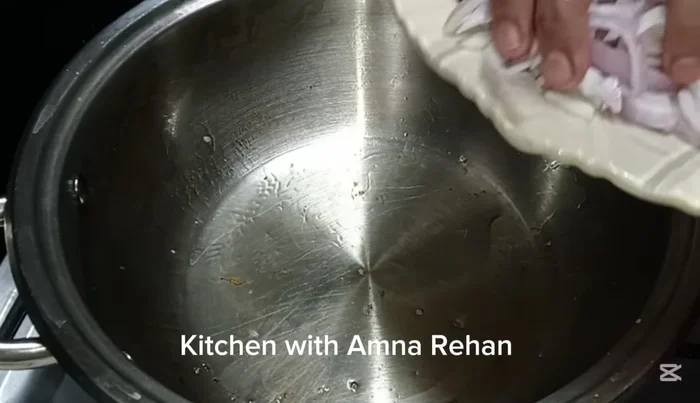 In the same pan, heat another half cup of oil. Add the sliced onion and cook until translucent.