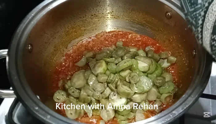 Add the fried ridge gourds to the masala. Mix well.