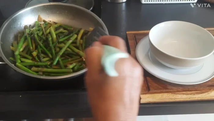 Serve the asparagus stir-fry immediately. Enjoy with the refreshing herbal drink.