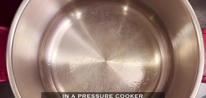 Heat oil in a pressure cooker, add cumin seeds, cinnamon, bay leaf, cardamom, and cloves. Crackle for 1 minute.