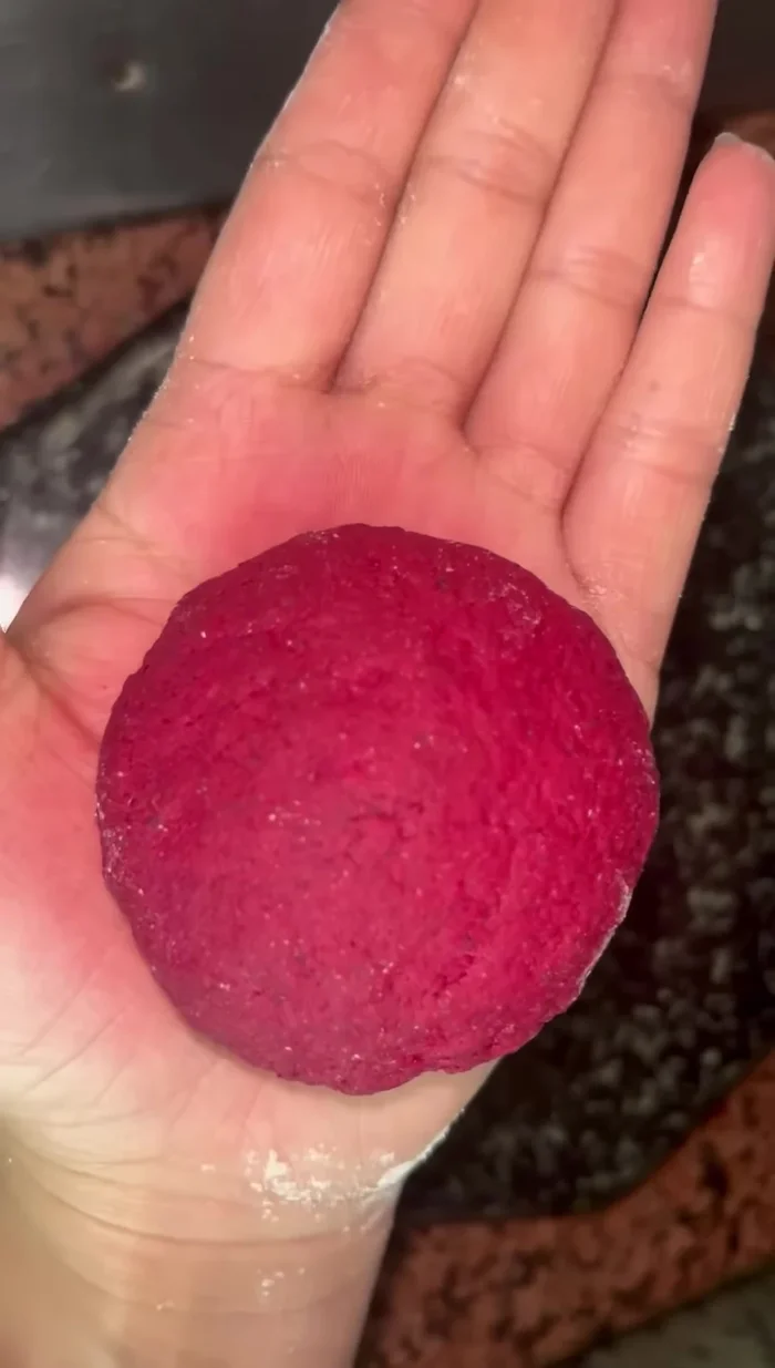 Make small dough balls and roll them out into parathas.