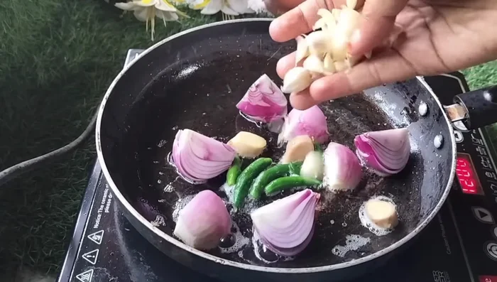 In the same pan, sauté chopped onions, green chilies, ginger, and garlic. (109.2)