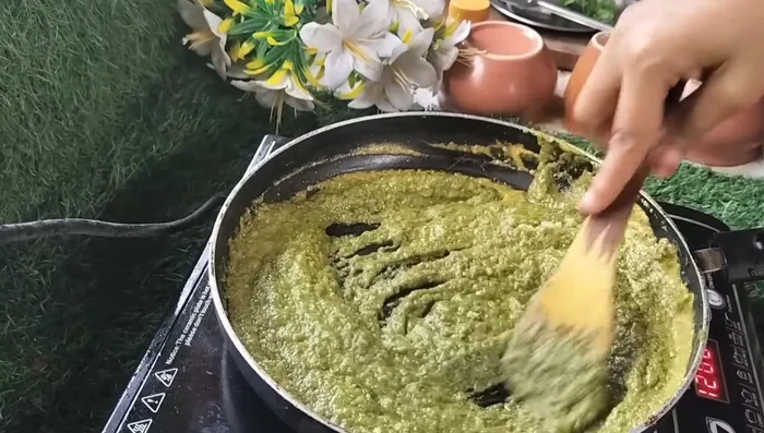 Cook the spices well with the curd paste, ensuring it doesn't stick to the bottom of the pan. (252.159)
