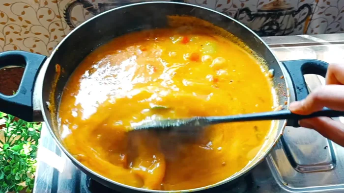 Add sambar masala and tamarind water; simmer until boiling.
