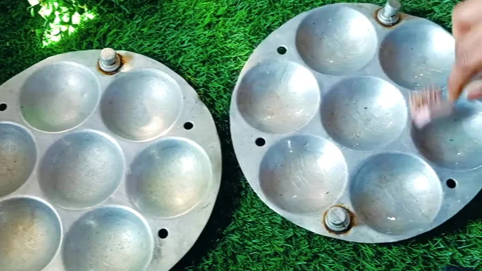 Grease the idli mould with oil and fill each compartment halfway with batter.