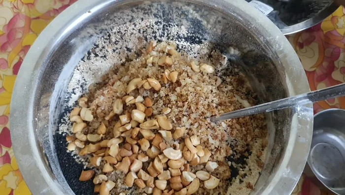 Combine ground chickpeas, chopped nuts, sesame seeds, fried coconut, and cashews.