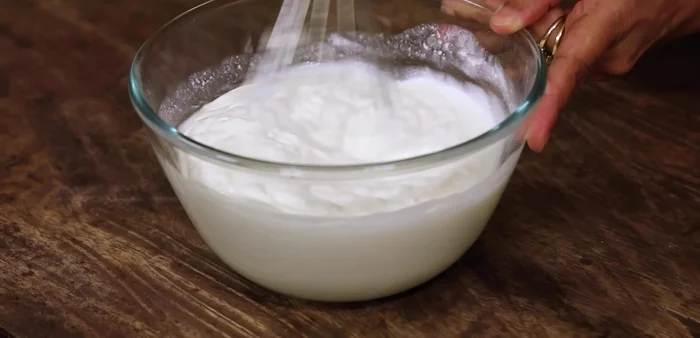 Whisk 1 cup of fresh curd until smooth and lump-free.