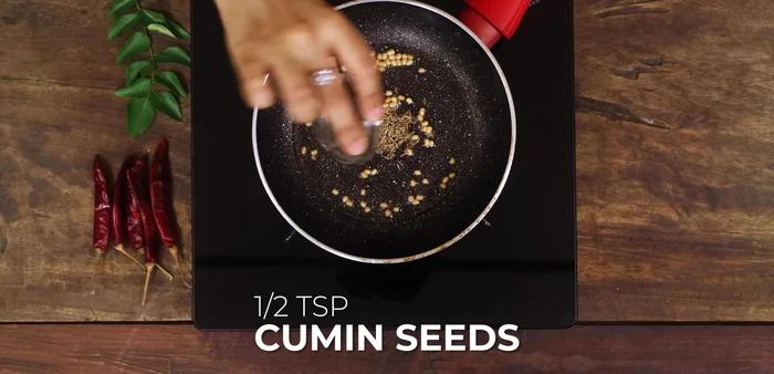 Add 1/2 teaspoon each of cumin seeds and mustard seeds.