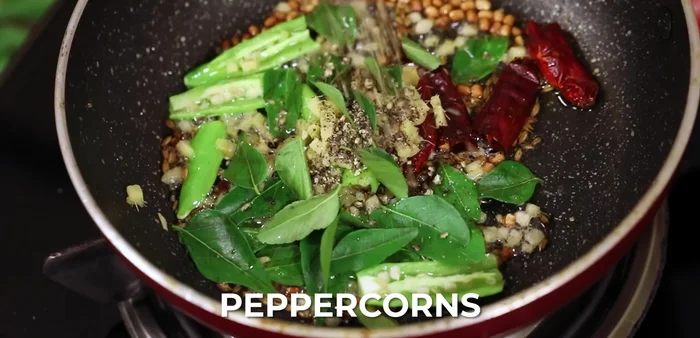 Add crushed peppercorns, 1/2 teaspoon asafoetida powder, and 1/2 teaspoon turmeric powder (optional).
