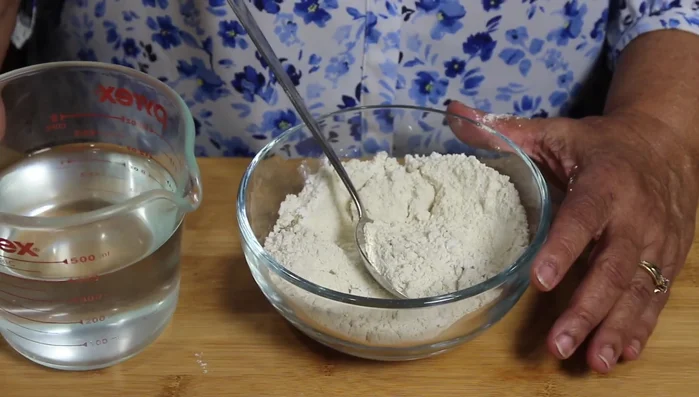 Gradually add water, while mixing to form a smooth, thin batter. Add water slowly, until the desired consistency is achieved.