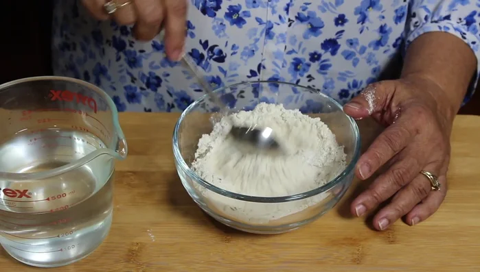 Mix all dry ingredients (sorghum flour, rice flour, fenugreek seeds, cumin seeds, black pepper, salt, and asafoetida) together in a mixing bowl.