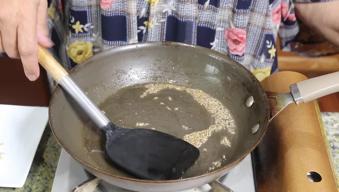 Add the boiled lotus stem slices to the pan.