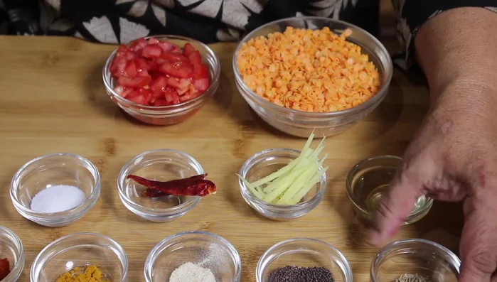 Heat oil in a pan. Add cumin seeds, mustard seeds, asafoetida, turmeric powder, red chili powder, and salt.