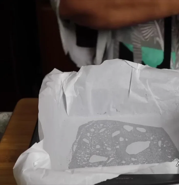 Pour mixture into a lightly oiled 8x8 inch baking pan lined with parchment paper. Spread lightly.