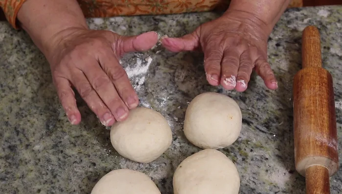 Place a spoonful of the potato mixture in the center of each circle. Bring the edges together and seal tightly. Gently roll into a paratha.