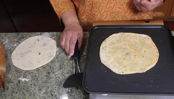 Heat a tawa (griddle). Cook the paratha on medium heat, flipping occasionally, until golden brown on both sides.