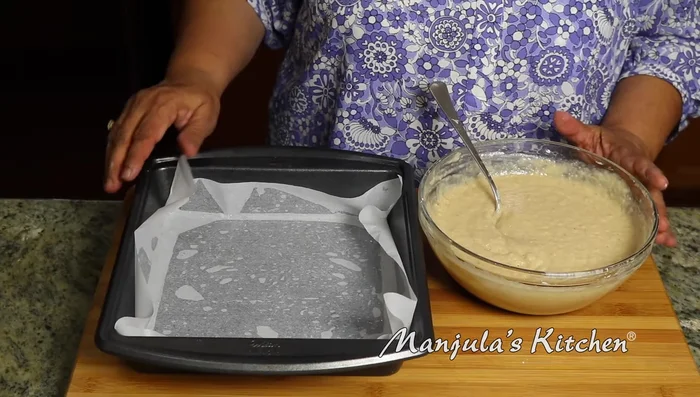 Pour the batter into a greased and parchment-lined 8x8 inch baking pan. Spread evenly.