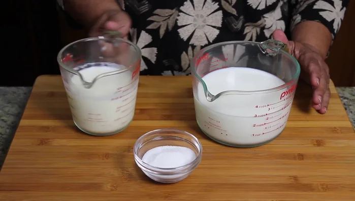 Boil milk with sugar, reduce to 1 1/2 cups, and refrigerate. (Note: This step is already done in the video)