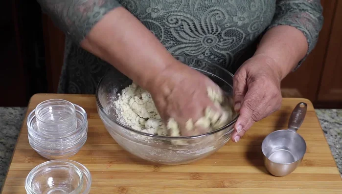 Let the dough rest for 10-15 minutes to allow the semolina to absorb the water.