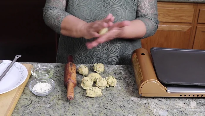 Roll each dough ball into a smooth ball between your palms.