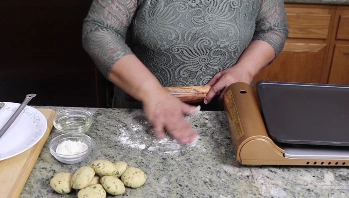 Lightly dust a surface with whole wheat flour. Roll each dough ball into a 3-inch diameter circle.