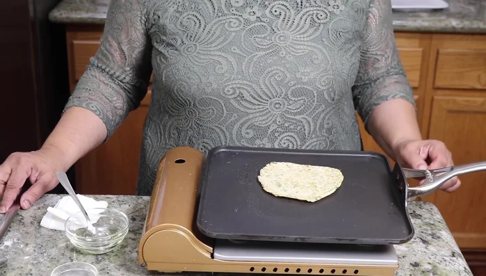 After flipping, add 1 teaspoon of oil to each side and cook until golden brown.