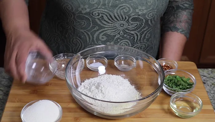 Mix all dry ingredients (semolina, all-purpose flour, whole wheat flour, chili flakes, salt, asafoetida, and mint) in a bowl.
