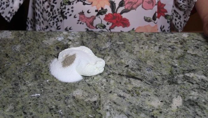 Add sugar and cardamom powder to the kneaded paneer and mix well until it forms a soft dough (this is called 'Sandesh').