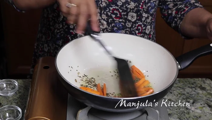Add carrots and stir-fry for about a minute.