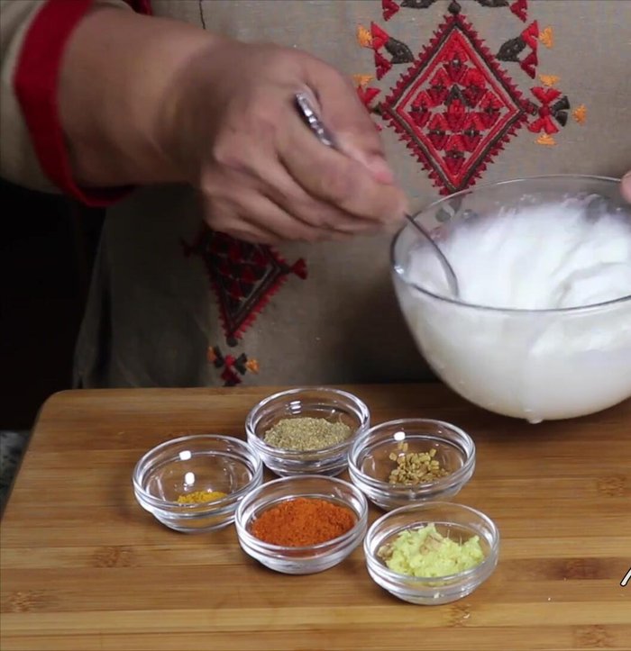 Mix spices (ginger, red chili powder, turmeric, coriander powder, fenugreek seeds) with yogurt. Whisk until smooth and creamy.