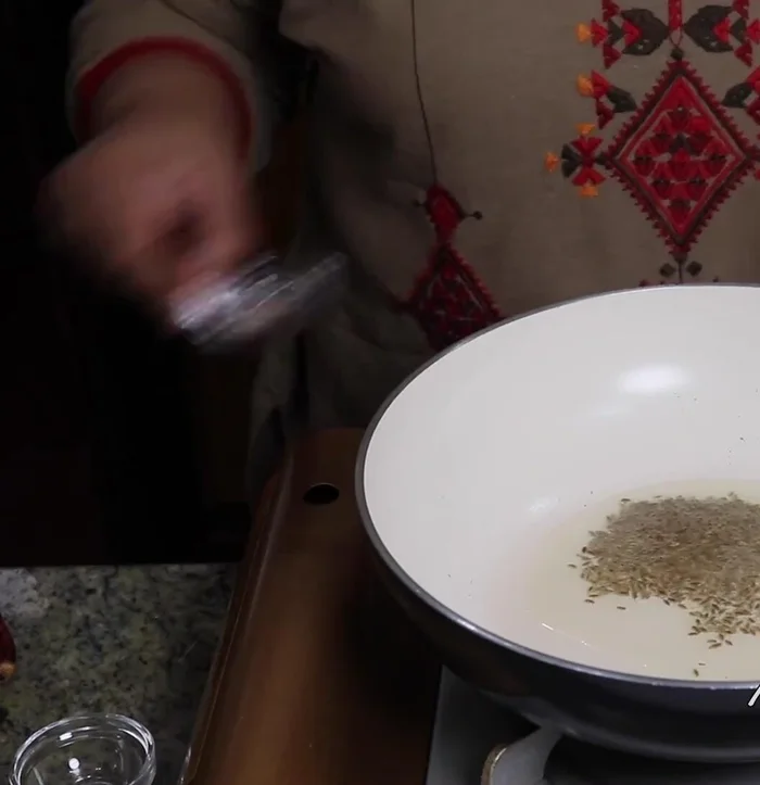 Add red chilies and sauté for a few seconds. Add the yogurt-spice mixture and stir continuously until it comes to a boil. Cook over low heat to prevent the yogurt from breaking.
