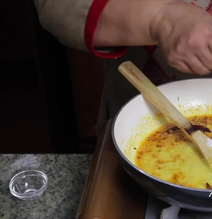 Add salt and break the papads into small pieces. Add them to the gravy and cook for another 3 minutes over low heat.