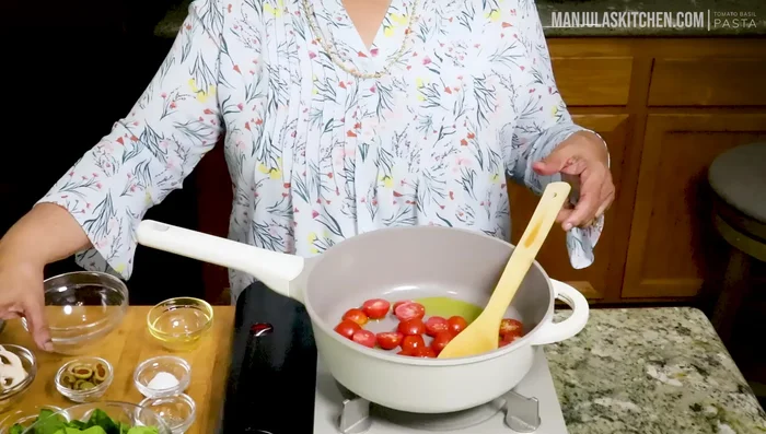 Add cherry tomatoes, sliced mushrooms, and green olives. Cook for 2-3 minutes until tomatoes soften.